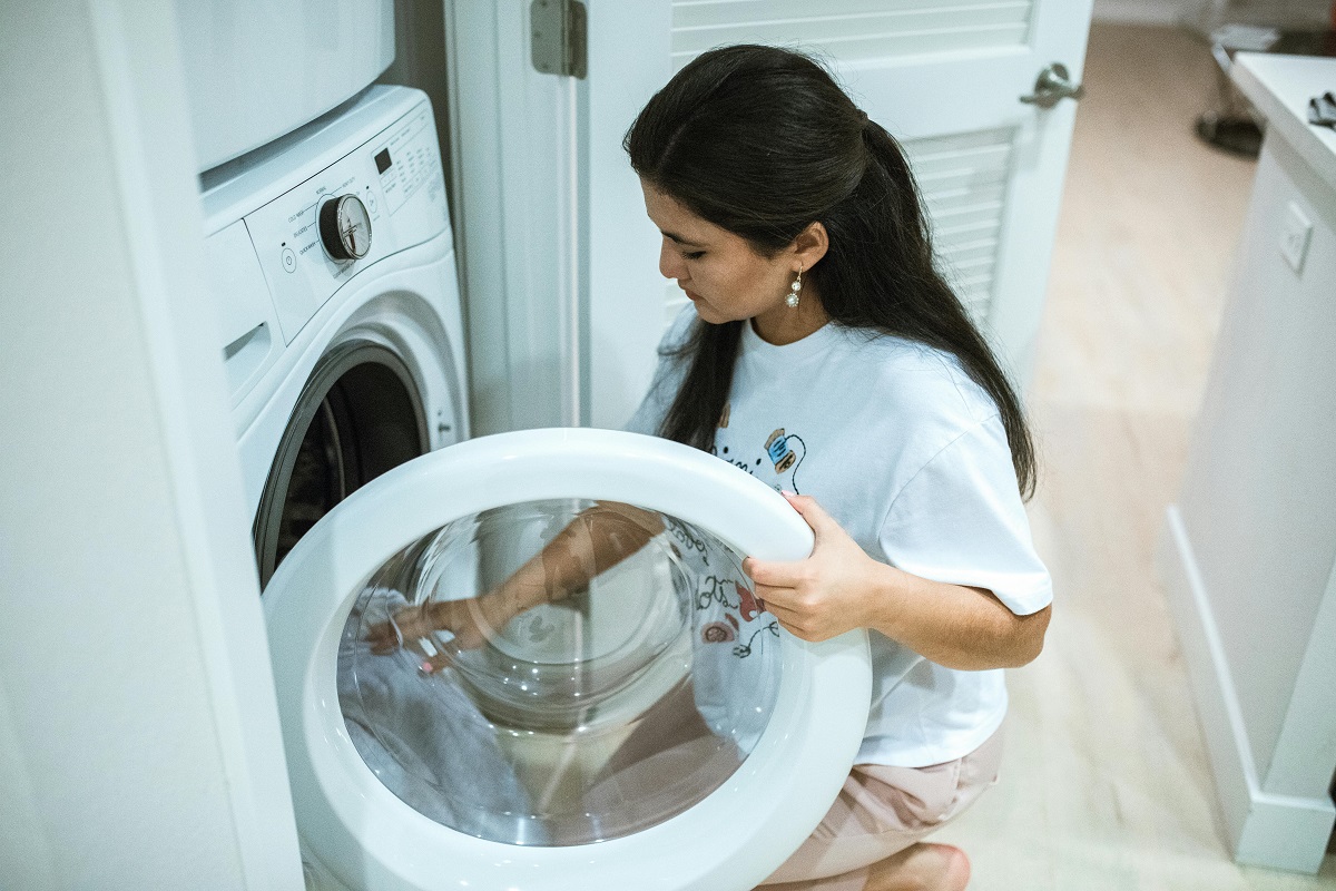 woman opening a washing machine door